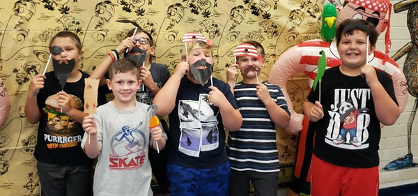 Students wear pirate costumes at summer reading party