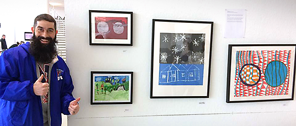 Justin Bursk with student artworks