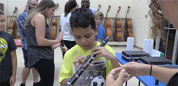 Student tries out a clarinet at Music Discovery Night