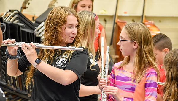 Neshaminy HS musician works with a younger student