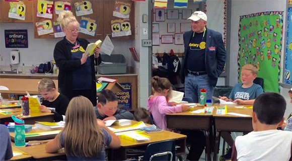 Rotarians handing out dictionaries at Buck Elementary