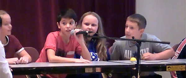 Sandburg students competing on stage for a game show