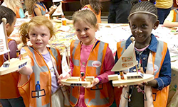 Students holding model boats