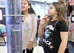 Students look at a model of the float
