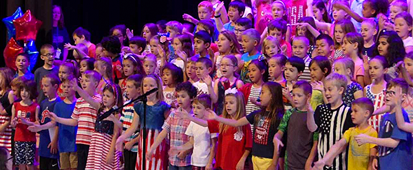 Tawanka students on stage singing