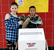 Students pose with Dunk Your Kicks donation box