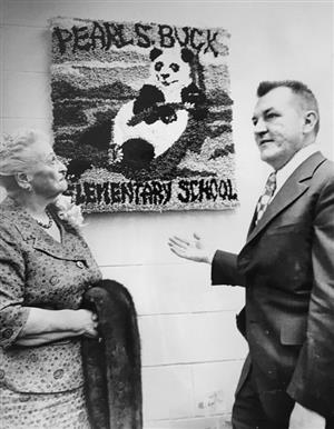 Pearl S. Buck talks with Buck Elementary principal in front of a panda artwork