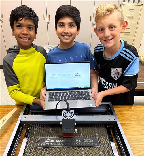 Students with laser engraving machine