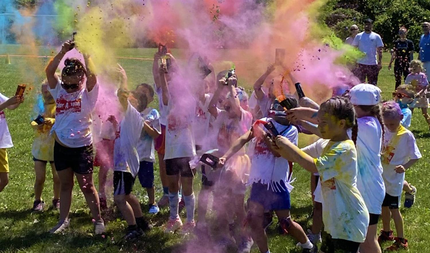 Students throwing colored powder during the Color Run